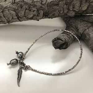 Silver bracelet with pearls and feather